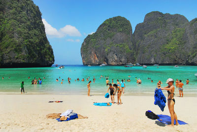 People at beach against sky