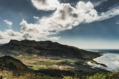 Scenic view of sea and mountains against sky