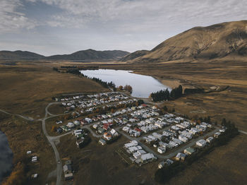 High angle view of lake and mountains against sky