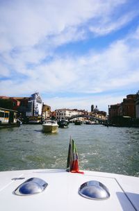 Boats in river with buildings in background