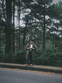 Portrait of man standing in forest