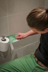 Rear view of boy in bathroom at home