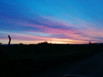 Silhouette landscape against scenic sky