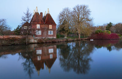 Reflection of trees and buildings on lake