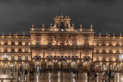 Group of people in front of building at night