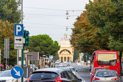 Cars on road in city against sky