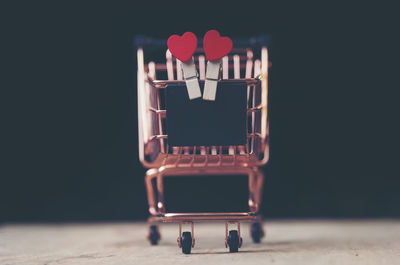 Close-up of toy on table against black background