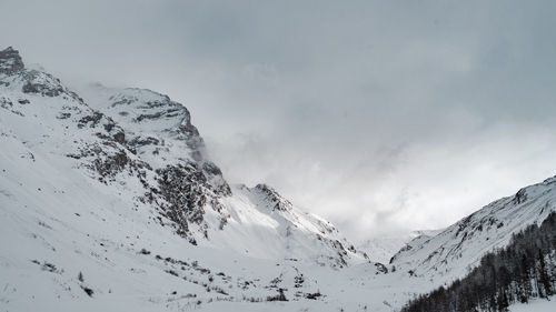 Scenic view of snow covered mountains against sky