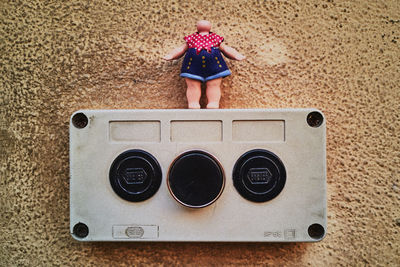 Rear view of boy standing against wall