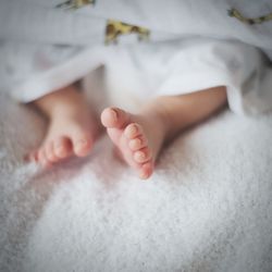 High angle view of baby sleeping on bed