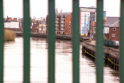 River by buildings in city