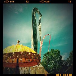 Low angle view of ferris wheel against sky