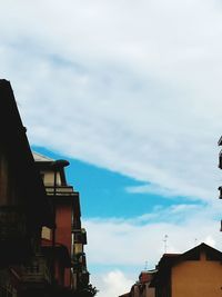 Low angle view of building against cloudy sky