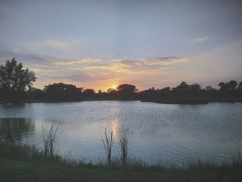 Scenic view of lake against sky during sunset