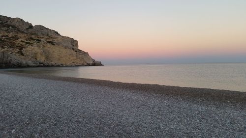 View of calm beach against clear sky