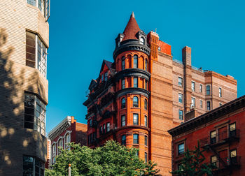 Low angle view of buildings against blue sky