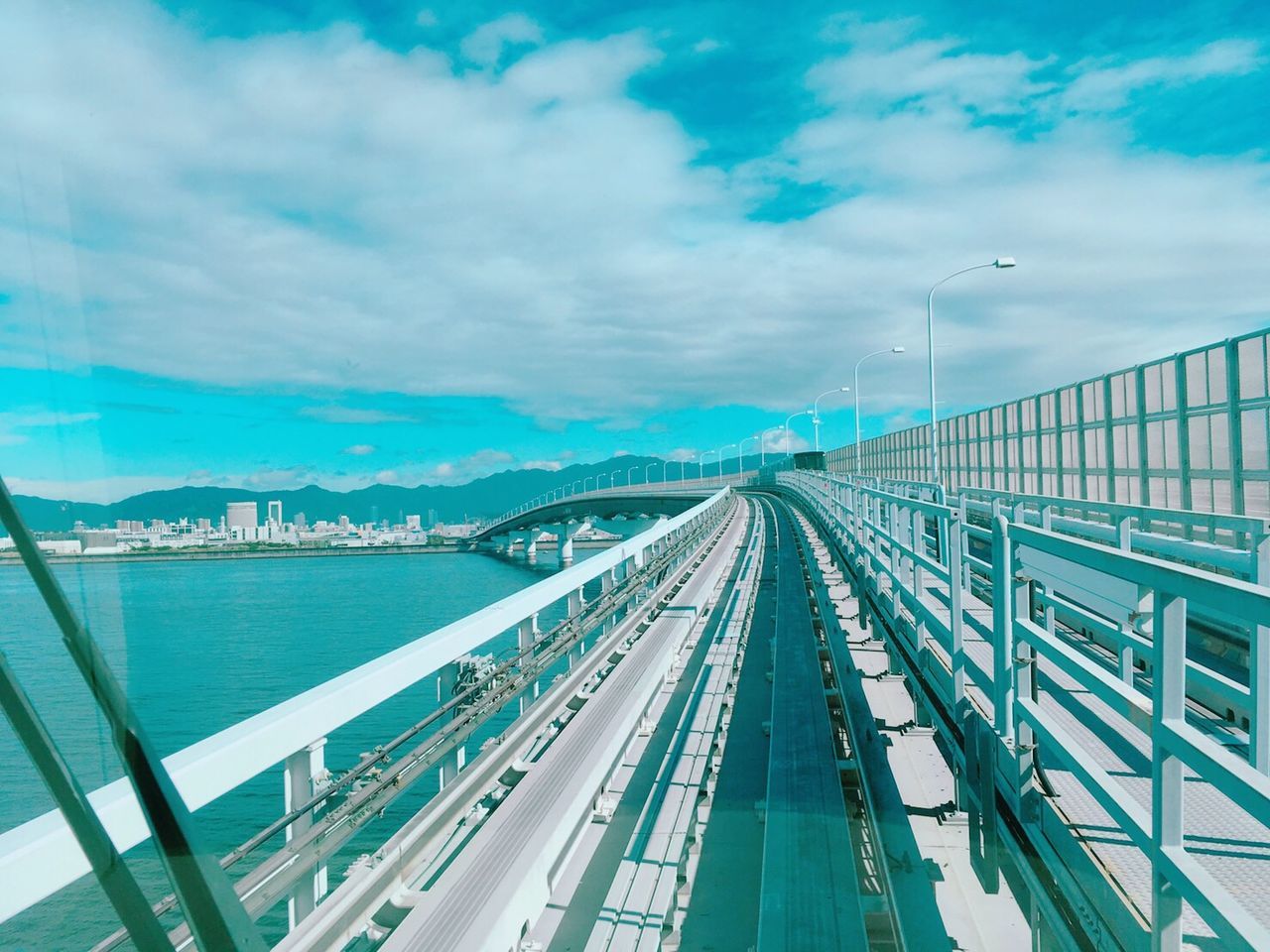 cloud - sky, sky, transportation, architecture, built structure, nature, day, connection, no people, bridge, water, bridge - man made structure, mode of transportation, rail transportation, city, high angle view, outdoors, travel, building exterior, track, multiple lane highway