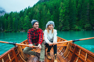 Full length of a smiling young couple in water