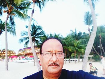 Portrait of man with palm trees