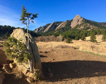 Scenic view of mountains against blue sky