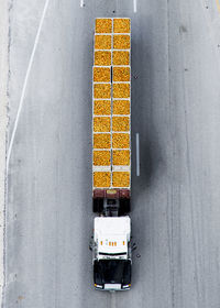 High angle view of truck with orange container on road