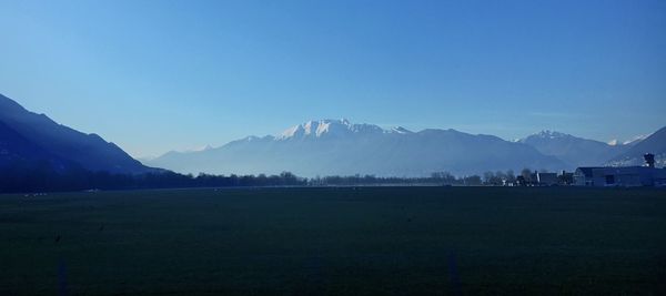 Scenic view of mountains against clear blue sky