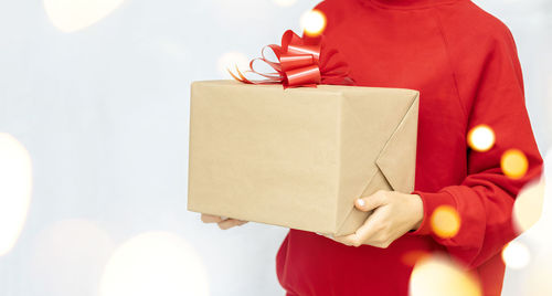 Close-up of woman holding paper in box