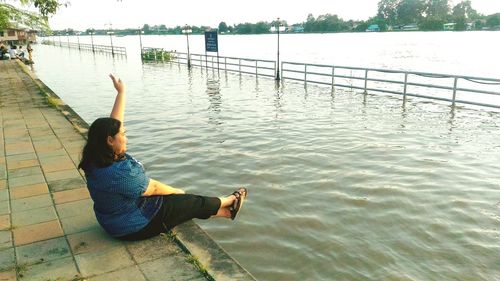 Full length of woman sitting in water