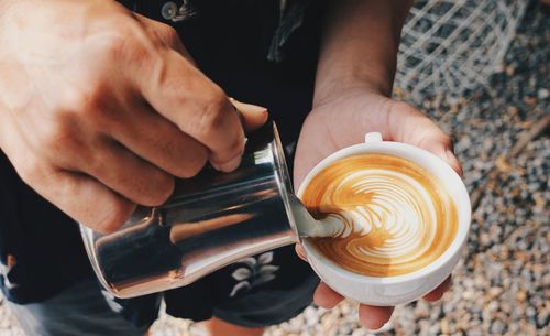 Midsection of man holding coffee