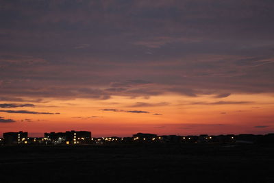 Silhouette cityscape against sky during sunset