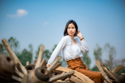 Portrait of young woman sitting outdoors