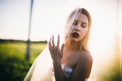 Portrait of woman against sky