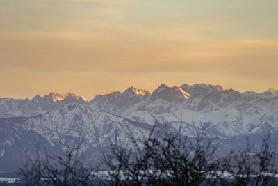 Scenic view of snowcapped mountains against sky during sunset