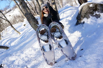 Full length of woman wearing snowshoe