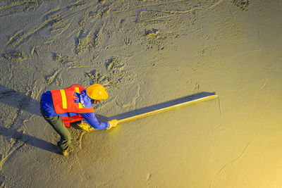 High angle view of man working on beach