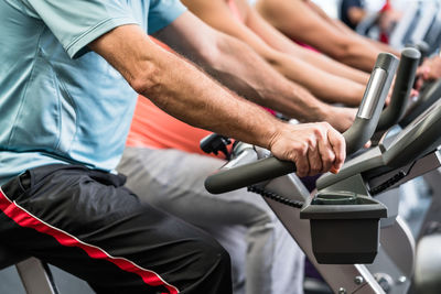 Midsection of people sitting on seat in bus