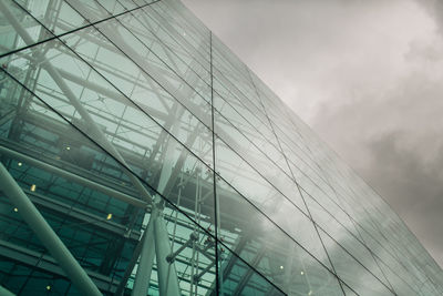 Low angle view of glass building against sky