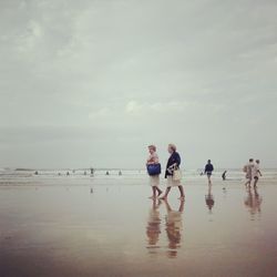 People enjoying at sea shore