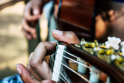 Close-up of hand playing guitar