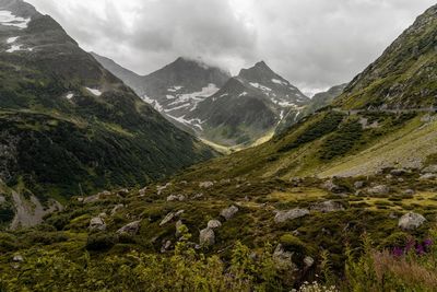 Scenic view of mountains against cloudy sky