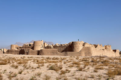 Low angle view of fort against clear blue sky