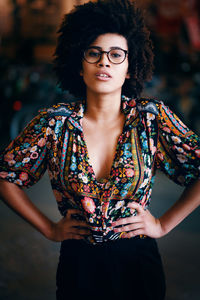 Portrait of beautiful woman standing against wall