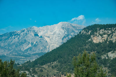 Scenic view of mountains against blue sky