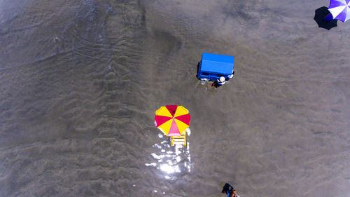 High angle view of people flying by sea