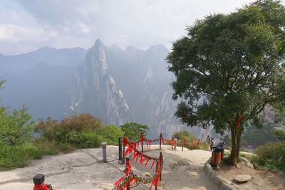 High angle view of people climbing on mountain against sky