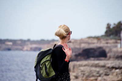 Side view of woman standing against clear sky