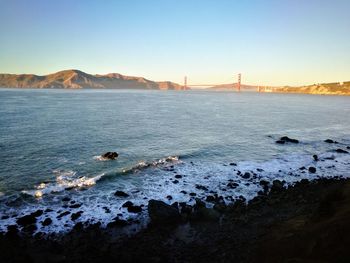 Scenic view of bay against clear sky