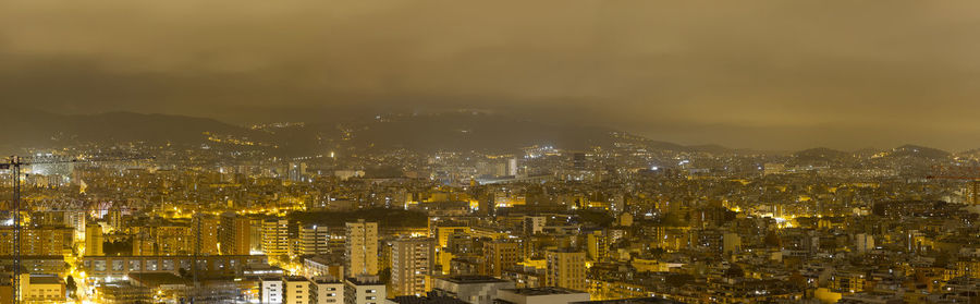 High angle view of illuminated city buildings at night