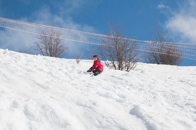 Kid playing in snowy mountain