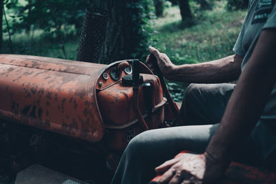 Midsection of man driving tractor